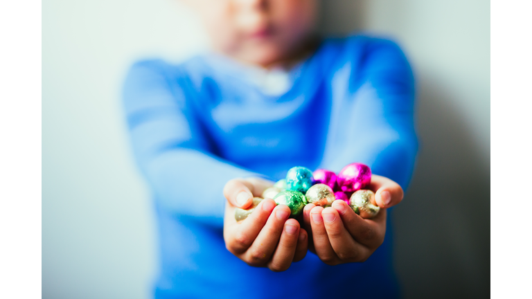 Little boy with chocolate easter eggs in his hands