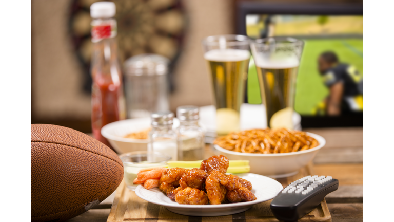 Watching football game on television at local pub. Food, beer.