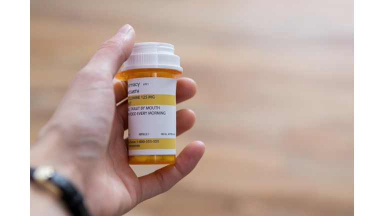 Man holds a prescription medication container