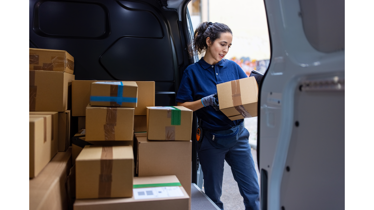 Courier checking the parcel for delivery