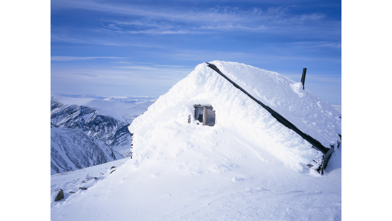 A snowed in cabin.