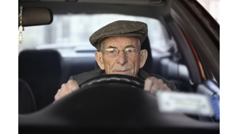 Portrait of a senior man driving a car