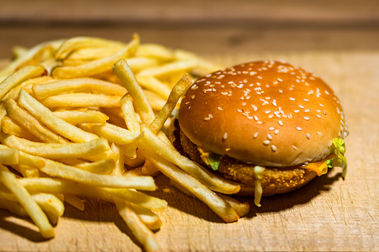 French fries and chicken burger on a wooden table. Food, junk food and fast food concept