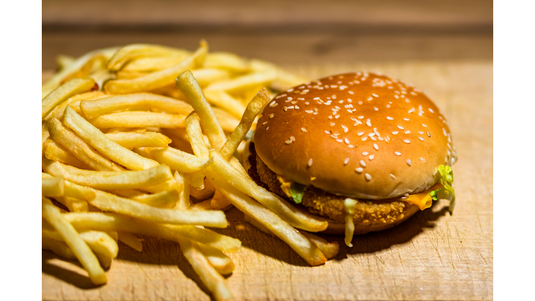 French fries and chicken burger on a wooden table. Food, junk food and fast food concept