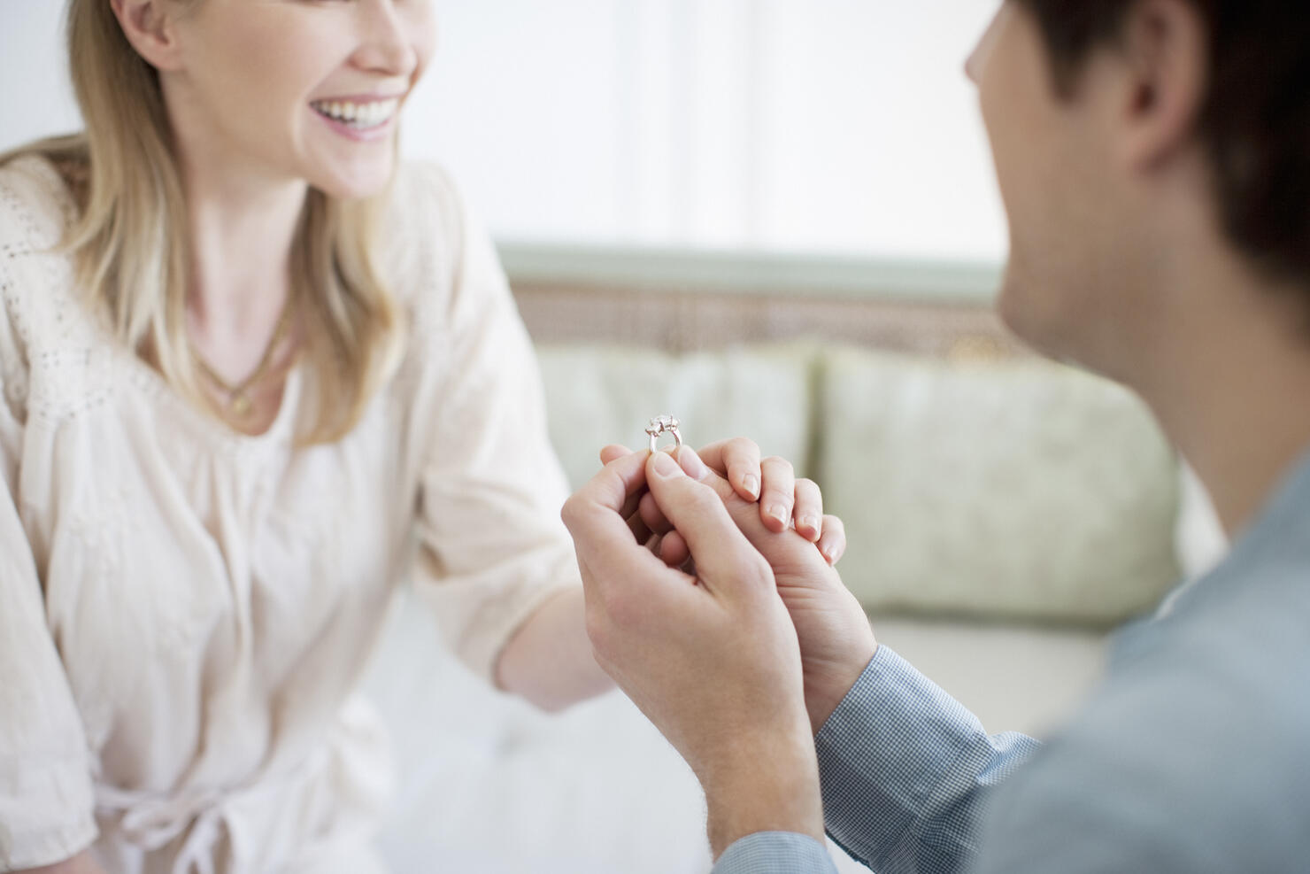 Man with engagement ring proposing marriage to woman