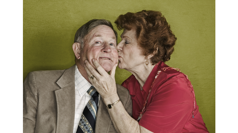 Senior woman kissing husband's cheek