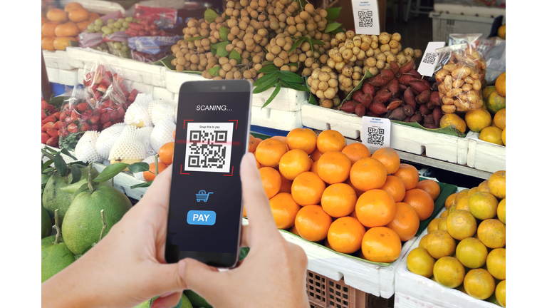 Qr code payment, E wallet , cashless technology concept. Man scanning tag Fresh Fruit in Market accepted generate digital pay without money.