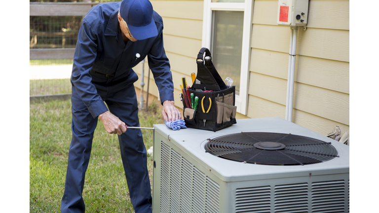 Technician services outside AC units and generator.