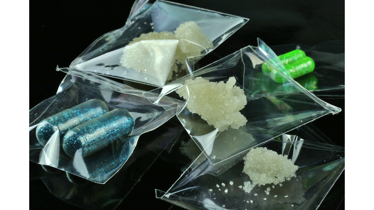 Individual bags of illegal drugs on a black background