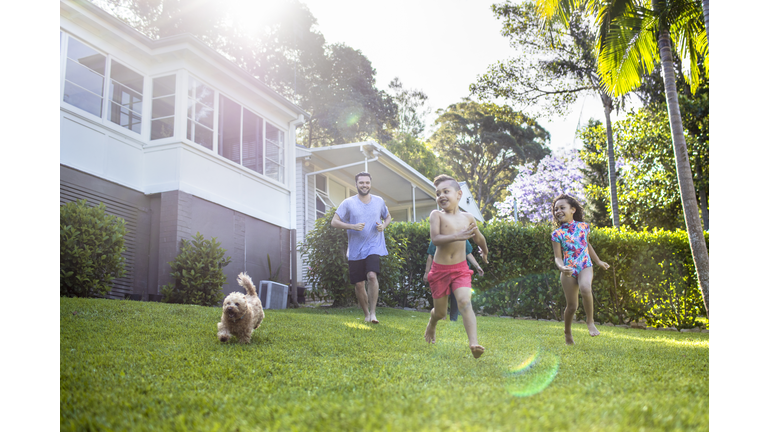 Aboriginal family enjoying the day in the garden at home