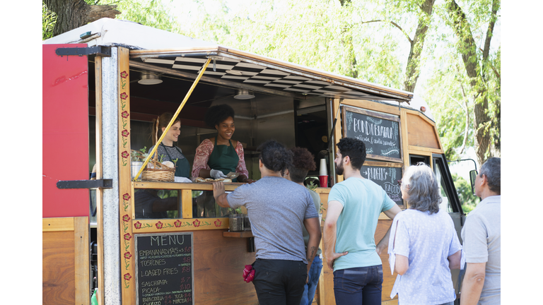 people making line to buy food from food truck