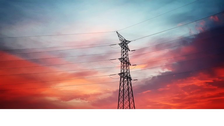 High voltage transmission tower at sunset