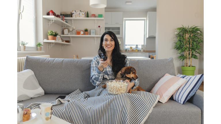 Woman sitting on the couch take some good time with her dog