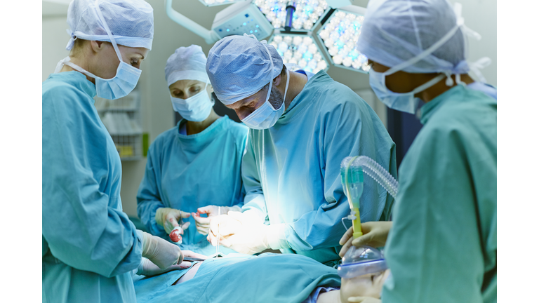 Surgeons performing surgery in operating room