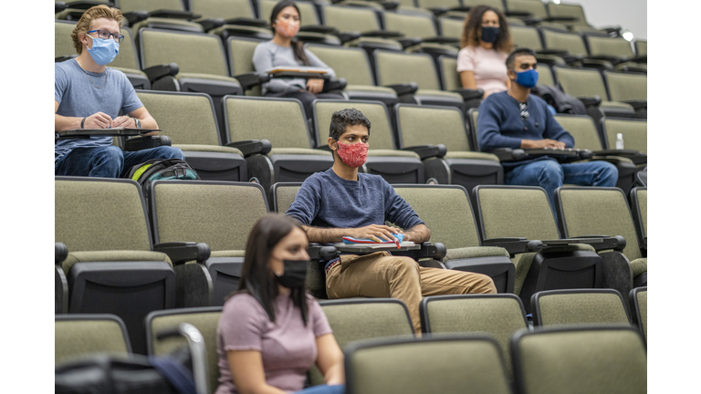 University students wearing masks in a lecture hall