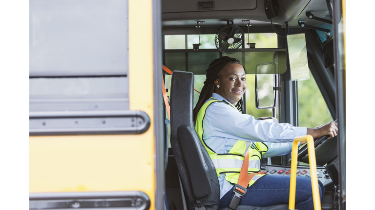 School bus driver looking through doorway