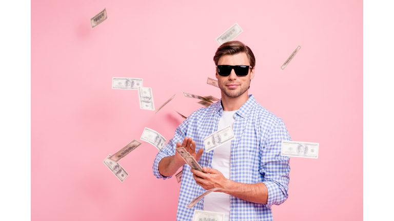 Portrait of his he nice cool trendy content attractive handsome candid guy wearing checked shirt throwing money flying in air party wealth isolated over pink pastel background