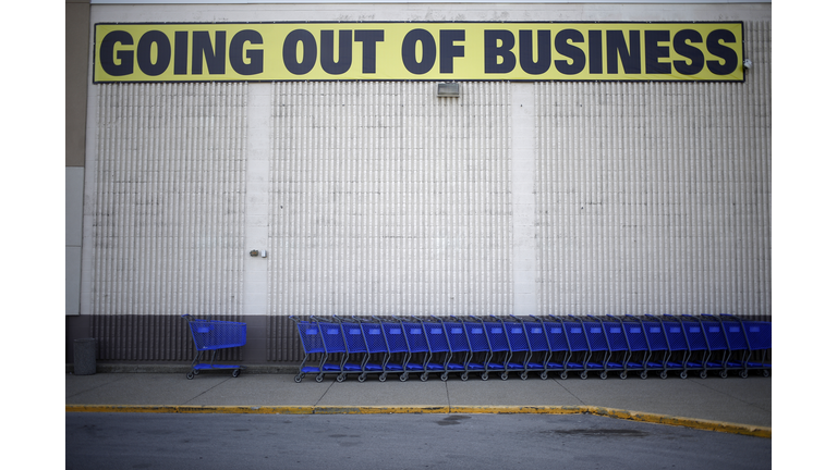 A "Going Out Of Business"sign is displayed outside a retail store