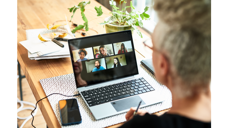 Senior businesswoman using laptop for team meeting video conference