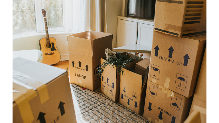 A Sunny Domestic room full of stacked Cardboard Boxes during the Relocation Process