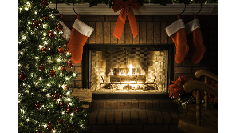 Decorated Christmas tree, blazing fire in fireplace, stockings, rocking chair