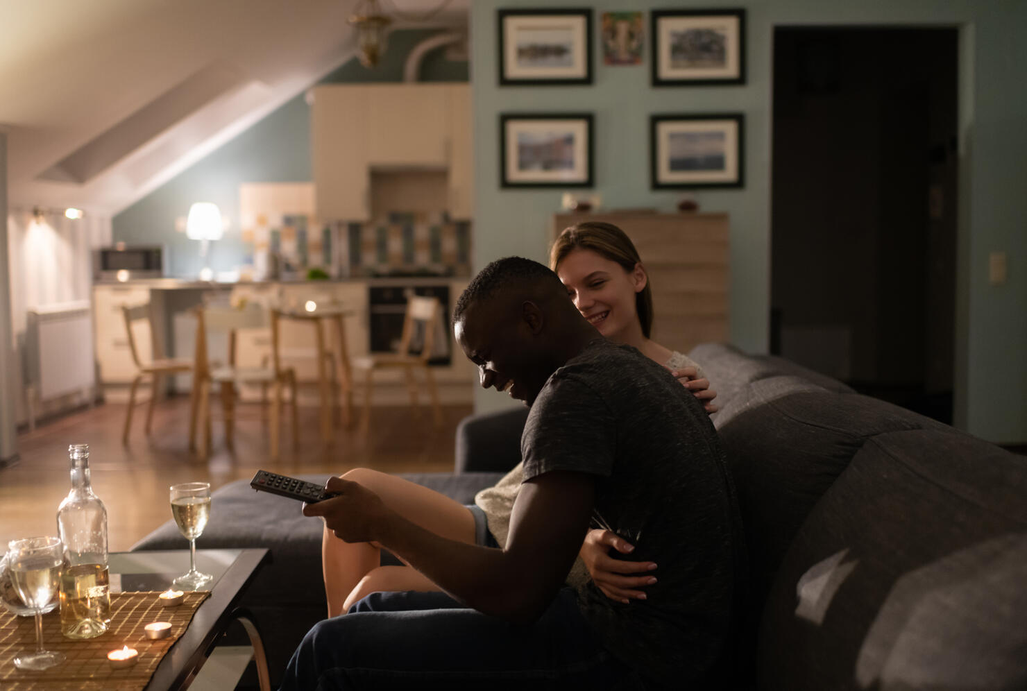 Excited diverse couple watching TV