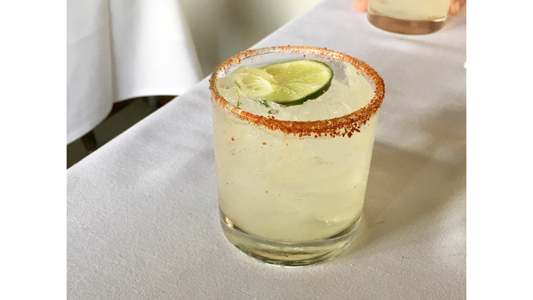 Chili-Salt Rimmed Paloma Cocktail on White Tablecloth
