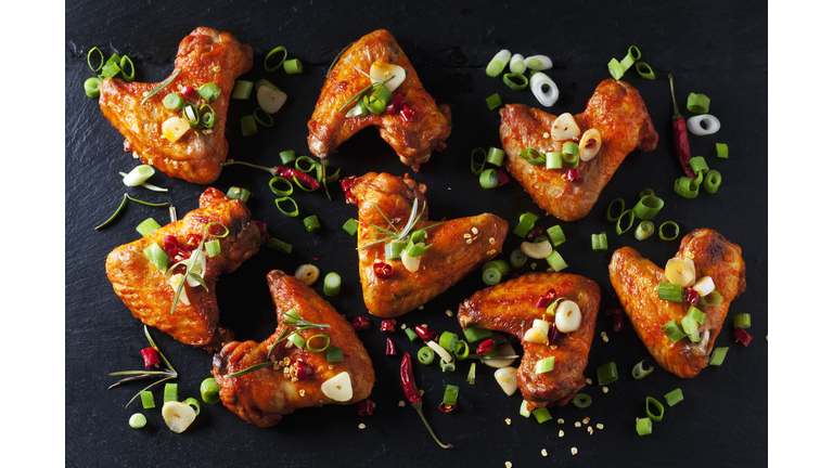 Marinated and grilled chicken wings on slate