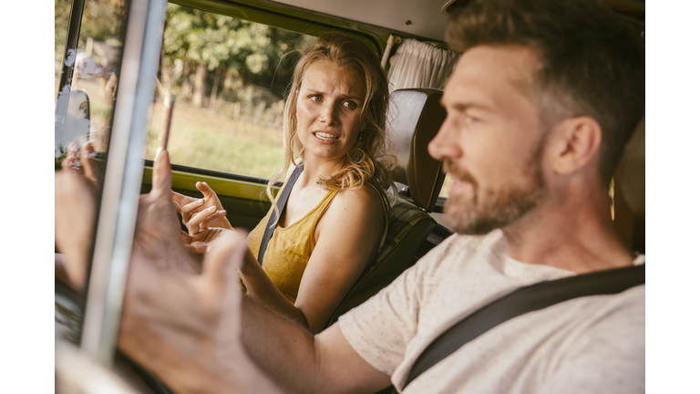 Couple arguing in van on a road trip