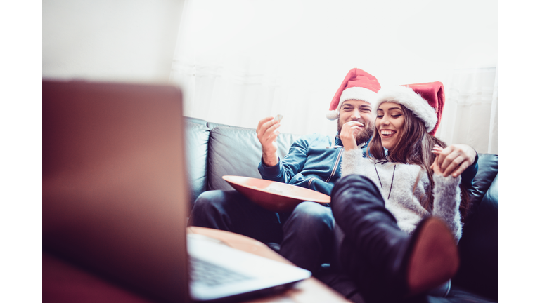 Cute Embraced Couple Watch Movie and Eat Snacks For Christmas Night