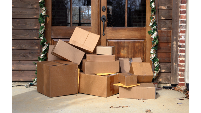 Shipping boxes near door on front porch of house during holiday shopping season