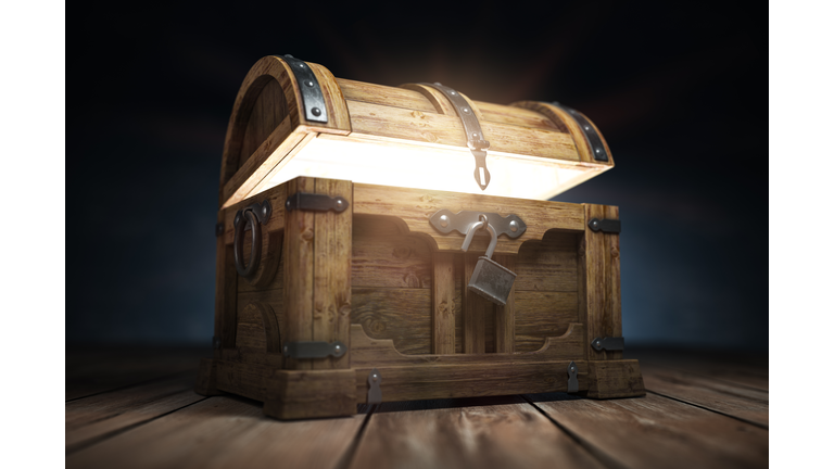 Old wooden treasure chest box with  glow from inside