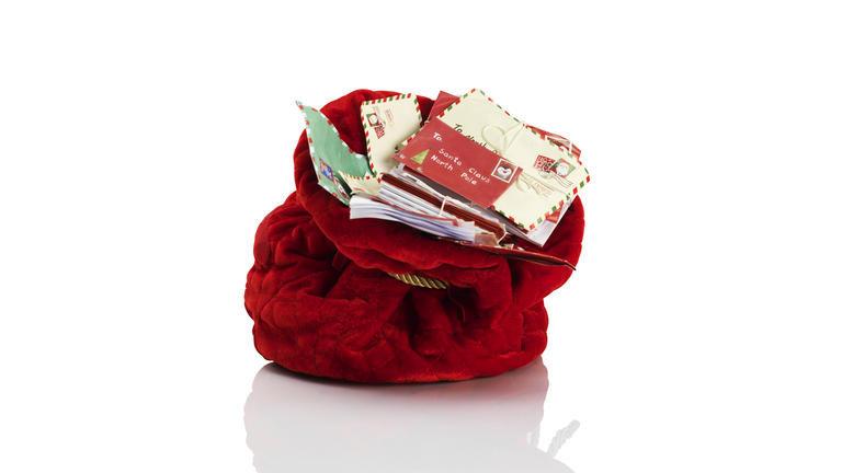 Red Santa Claus mailbag stuffed with letters