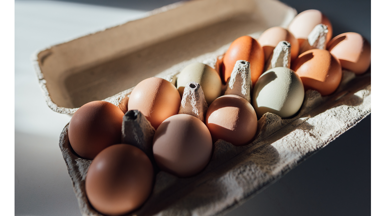 Farm fresh carton of eggs on white surface