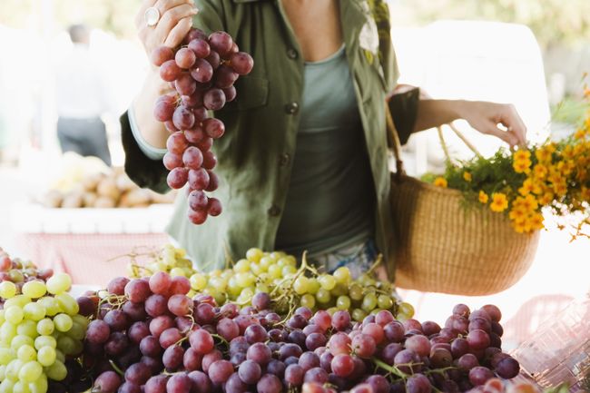 Woman with grapes at farmer's market