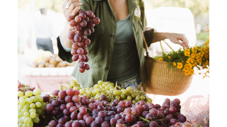 Woman with grapes at farmer's market