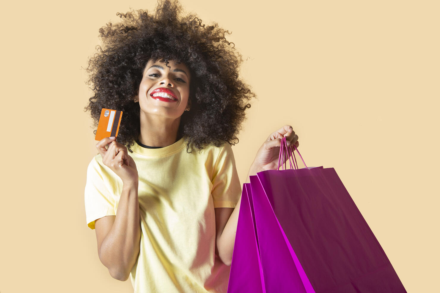 pretty south american woman with shopping bags and credit card, black friday