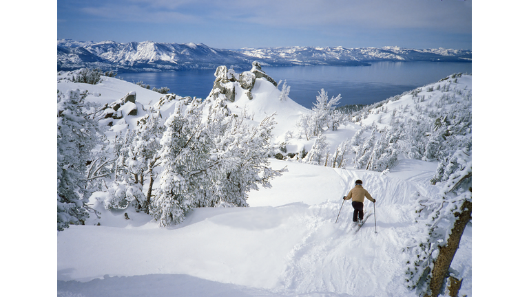 Skier in Fresh Snow Above Alpine Lake Tahoe