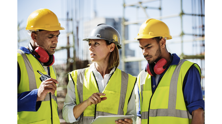 Architects using digital tablet at site