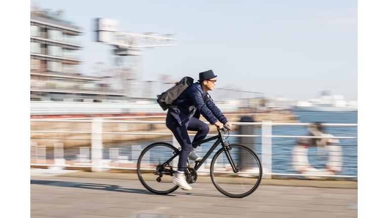 A man rides a bicycle to work in the town of Bayside in the morning