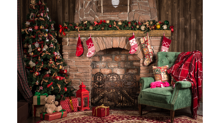 Christmas decorations of the room: fireplace, chair, tree