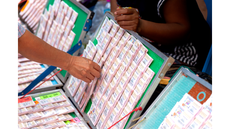 hand picking Thai government lottery tickets