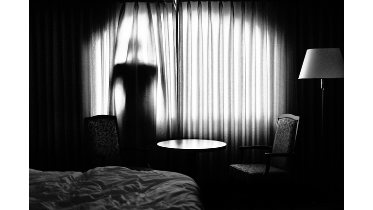 Man behind a curtain back