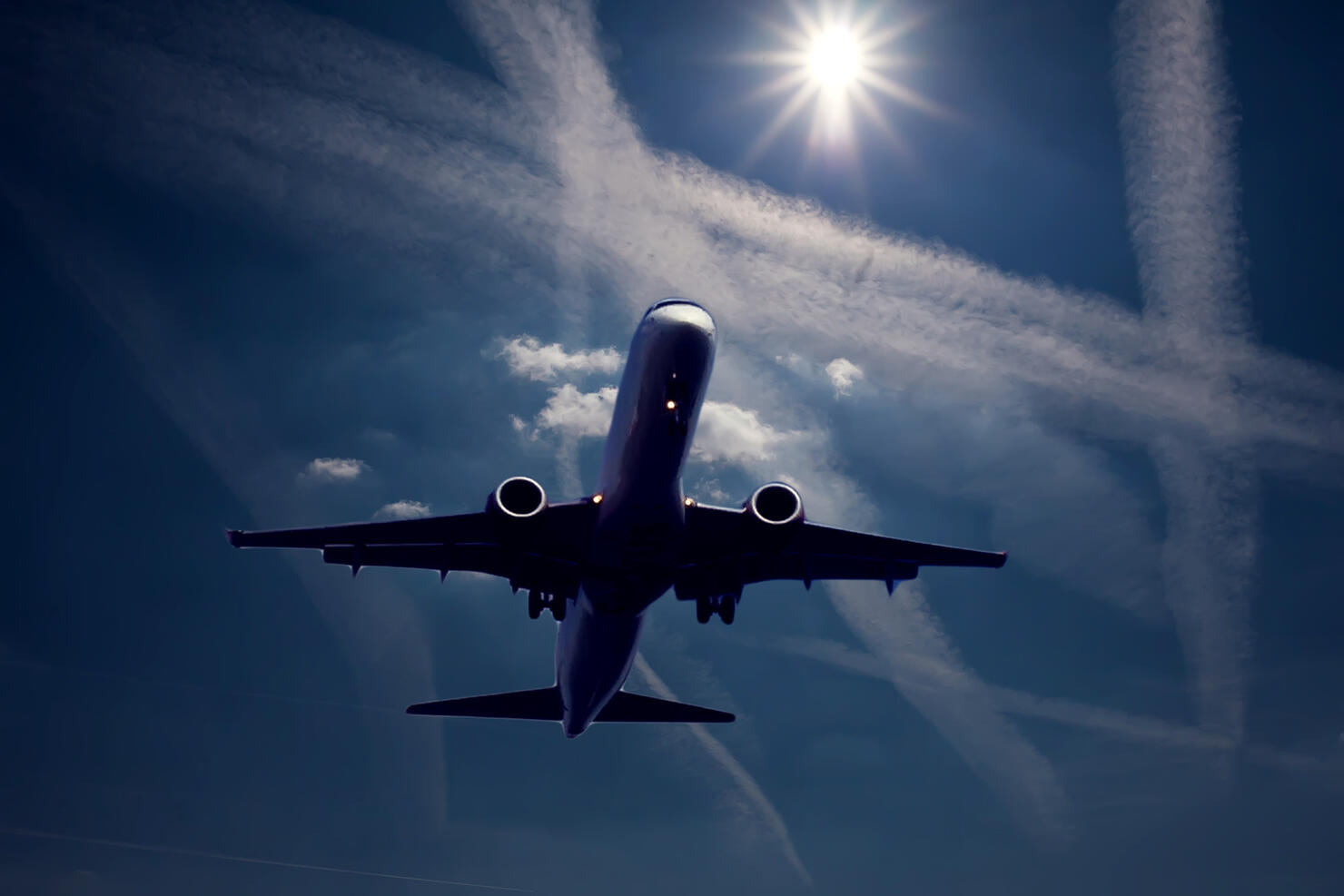 Plane in the sky with chem trails. Environmental pollution concept