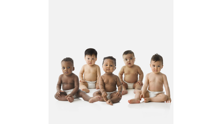 Studio shot of babies in diapers sitting