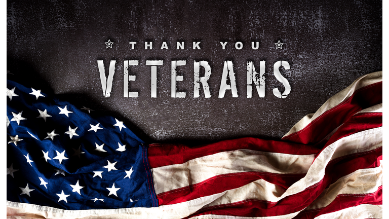 Happy Veterans Day concept. American flags against a dark stone  background. November 11.