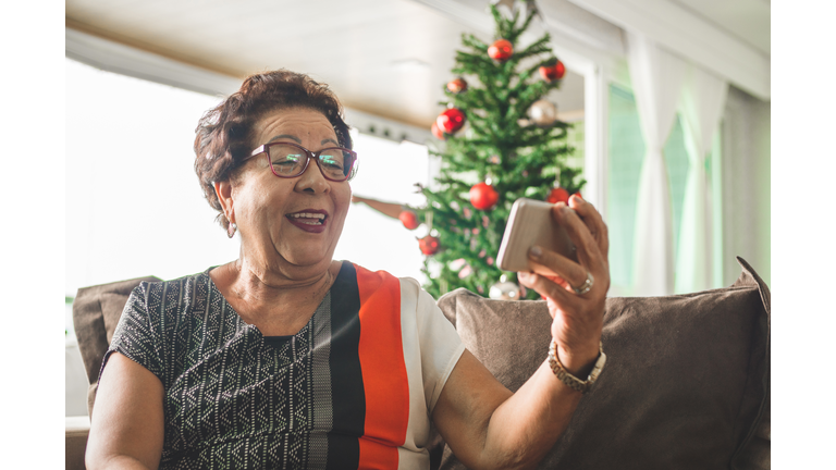 Grandma receiving christmas message by smart phone