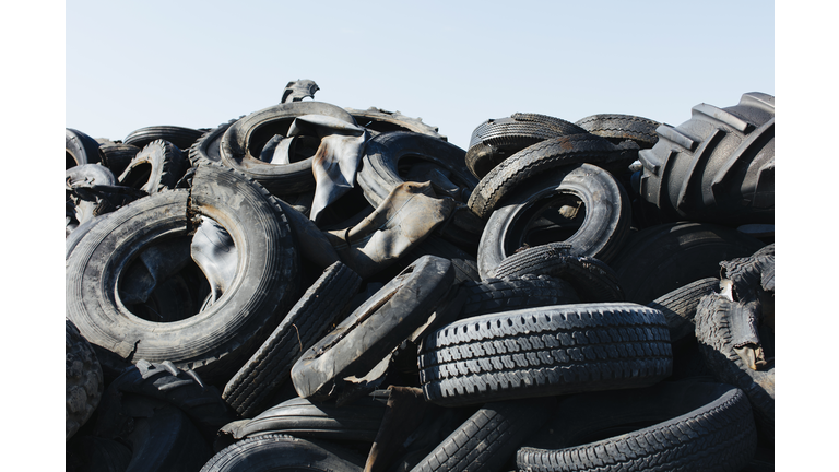 Pile of discarded auto and tractor tires in rural landfill, abandonned farms