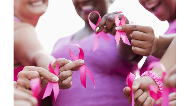 Group of women in pink, breast cancer awareness ribbons