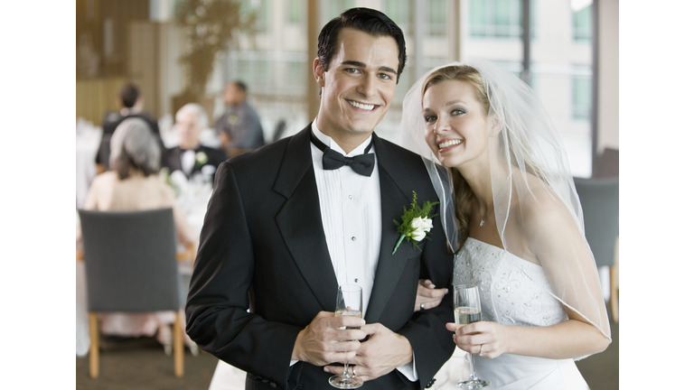 Portrait of bride and groom with drinks